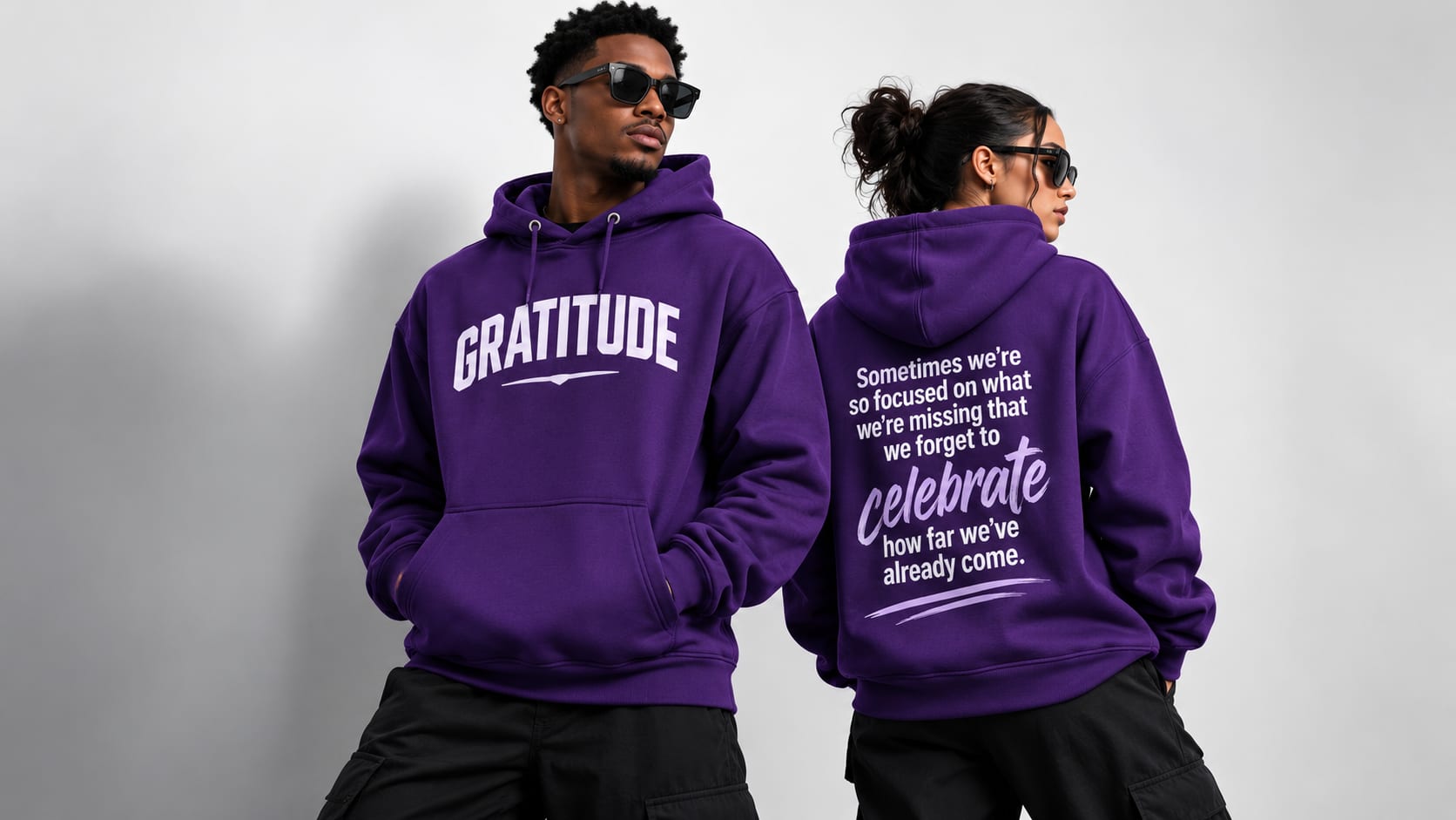 Couple in purple Gratitude hoodies, front and back graphic
